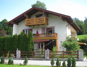 a house with a balcony on top of it at Ferienwohnungen Schmidt in Berchtesgaden