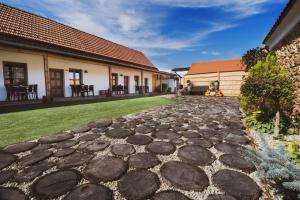 a stone walkway in the yard of a house at Penzion Castello in Valtice