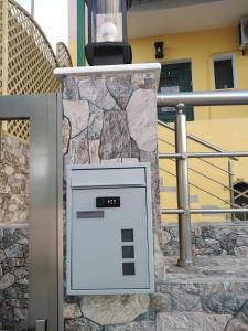 a machine is sitting in front of a stone wall at Serafi Cozy Rooms in Archangelos