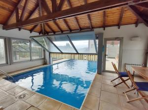 a large swimming pool with blue water in a house at Quinta Luna NH in San Carlos de Bariloche