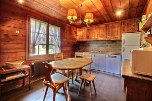 a kitchen with a table and chairs in a room at Chalet Nouchka VERB120 in Verbier