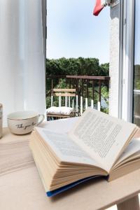 an open book sitting on a table next to a window at Hotel Brennero in Verona