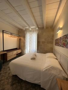 Letto o letti in una camera di Antico Mondo Rooms & Suites