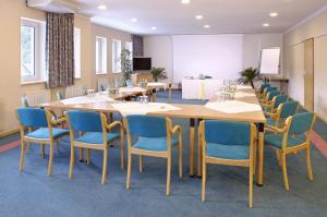 una sala de conferencias con una mesa larga y sillas en Hotel Hecher, en Wolfsberg