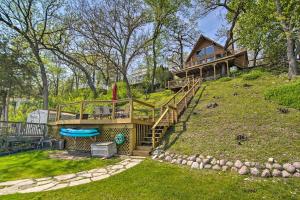 a house on a hill with a deck and a pool at Serene Lakefront Escape Boat Dock and Grill! in Twin Lakes