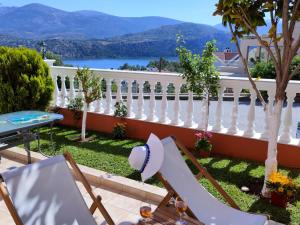 a balcony with a white fence and a table at Blue Lagoon Luxury Apartment B2 in Argostoli +40 photos