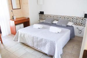 Postel nebo postele na pokoji v ubytování Largo Imperiali B&B