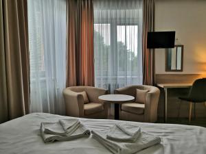 Postel nebo postele na pokoji v ubytování EA Hotel Lipno