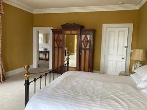a bedroom with a large bed and a hallway at Inver in Cobh