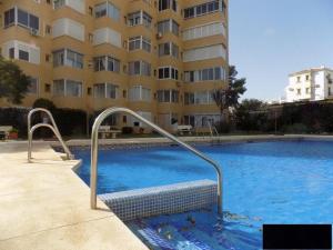 una gran piscina frente a un edificio en Precioso apartamento junto a playa y con piscina., en Málaga
