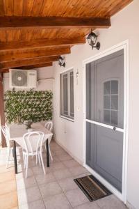 a patio with a table and a large sliding door at Sunrise Apartment in Heraklio