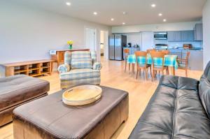 a living room with a couch and a table at Franconia Heights Sustainable Mtn Apartment in Franconia
