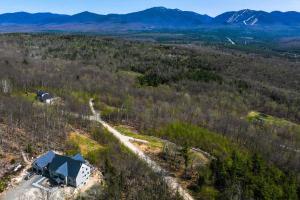 an aerial view of a house in a forest at Franconia Heights Sustainable Mtn Apartment in Franconia