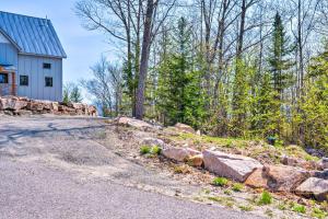 a stone retaining wall next to a house at Franconia Heights Sustainable Mtn Apartment in Franconia +19 photos