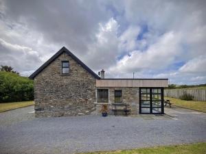 a stone building with a picnic table in front of it at Cottage 426 - Moyard in Moyard