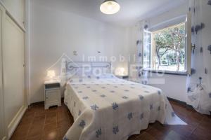 Posteľ alebo postele v izbe v ubytovaní 15 FARO - Confortevole bilocale sulla spiaggia di Porto Faro
