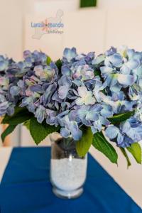 un jarrón lleno de flores azules y blancas en una mesa en Vivienda Vacacional El Tucan, en Tías