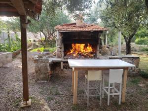 a table and chairs in front of a fireplace at Apartmani Maria in Preko