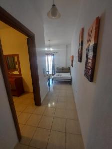 a hallway leading to a living room with a couch at Kostas Apartments in Ierissos