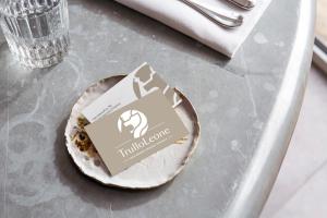 a small plate on a table with a sticker on it at Trullo Leone in Martina Franca