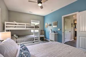 a bedroom with two bunk beds and blue walls at Grill and Fire Pit Blue Cabin Ozarks Getaway! in Camdenton