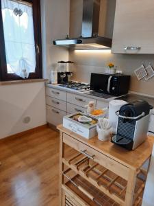 a kitchen with a counter with a microwave and a stove at B&B Girasoli in Ascoli Piceno