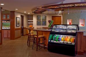 a restaurant with a bar and a drink cooler at Hyatt Place Sterling Dulles Airport North in Sterling