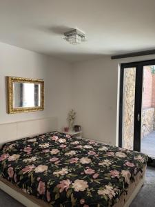 een slaapkamer met een bed met een bloemenbed bij Emifüred in Balatonfüred