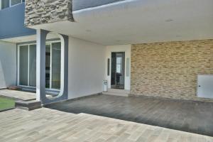 an external view of a building with a brick wall at 5 VENATOR House Boutique in León