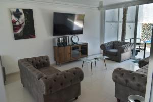 a living room with a joker on the wall at 5 VENATOR House Boutique in León