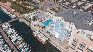 an aerial view of a building next to a marina at Mosella Suite Hotel in Sottomarina
