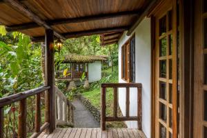 an open door to a porch of a house at Rancho Margot Sustainable & Self Sufficient Eco Lodge in El Castillo de La Fortuna