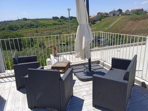 a patio with an umbrella and chairs and a table at Villa Caravaggio Comfort e Relax in Rocca San Giovanni