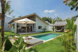 a villa with a swimming pool and a house at The Bingin Beach Villas' Private Villas in Uluwatu