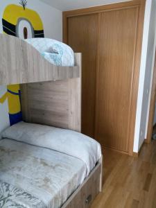 A bed or beds in a room at boiro playa barraña