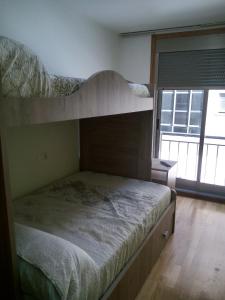 A bed or beds in a room at boiro playa barraña