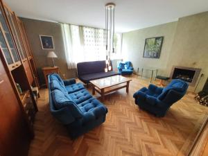 a living room with blue couches and a table at Before reconstruction chance in Jūrmala