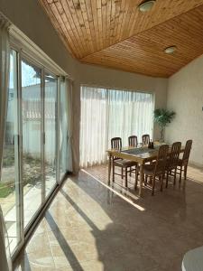 a dining room with a wooden table and chairs at Приятна къща за почивка Караколев 2 in Obrochishte