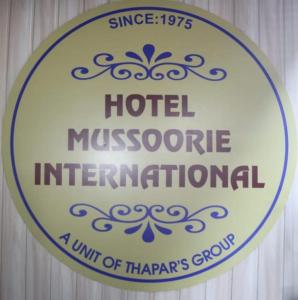 a sign for a hotel microeconomic international at Hotel Mussoorie International in Mussoorie