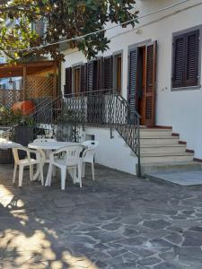 a patio with tables and chairs in front of a building at Trilocale Il timone in Fetovaia