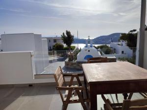 a table and chairs on a balcony with a view at Drimoni Boutique in Ios Chora