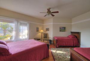 a bedroom with two beds and a ceiling fan at Banning House of Two Harbors in Two Harbors