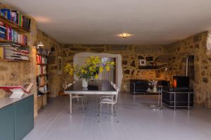 a room with a table with chairs and a vase of flowers at Special Farmstay, Faia-Guarda in Faia