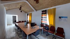 a conference room with a long table and chairs at Jozene House in Ngaparou +93 photos