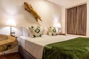 a bedroom with a bed with a fish on the wall at Candilejo Hotel Boutique in Cartagena de Indias