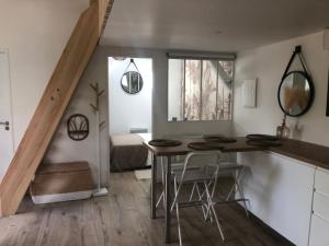 a kitchen with a table and chairs in a room at La grange de l ocean SPA in Linxe