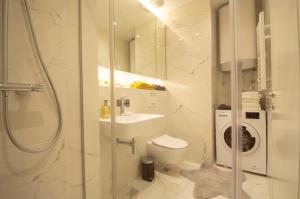 a bathroom with a shower and a toilet and a sink at STUDIO K district (central BG+private parking) in Belgrade