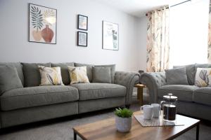 a living room with a couch and a table at The Flintshire - North Wales - Sleeps Up To 9 in Flint