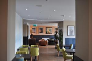 a lobby with chairs and tables and a living room at Bude Hotel - An Mor in Bude