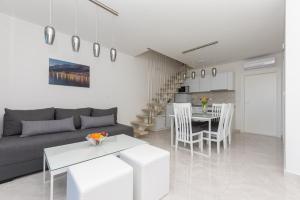 a living room with a couch and a table at Apartments M&A in Makarska